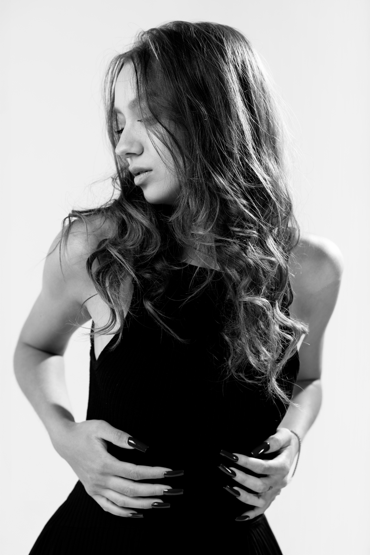 Black and white portrait with long waved hair